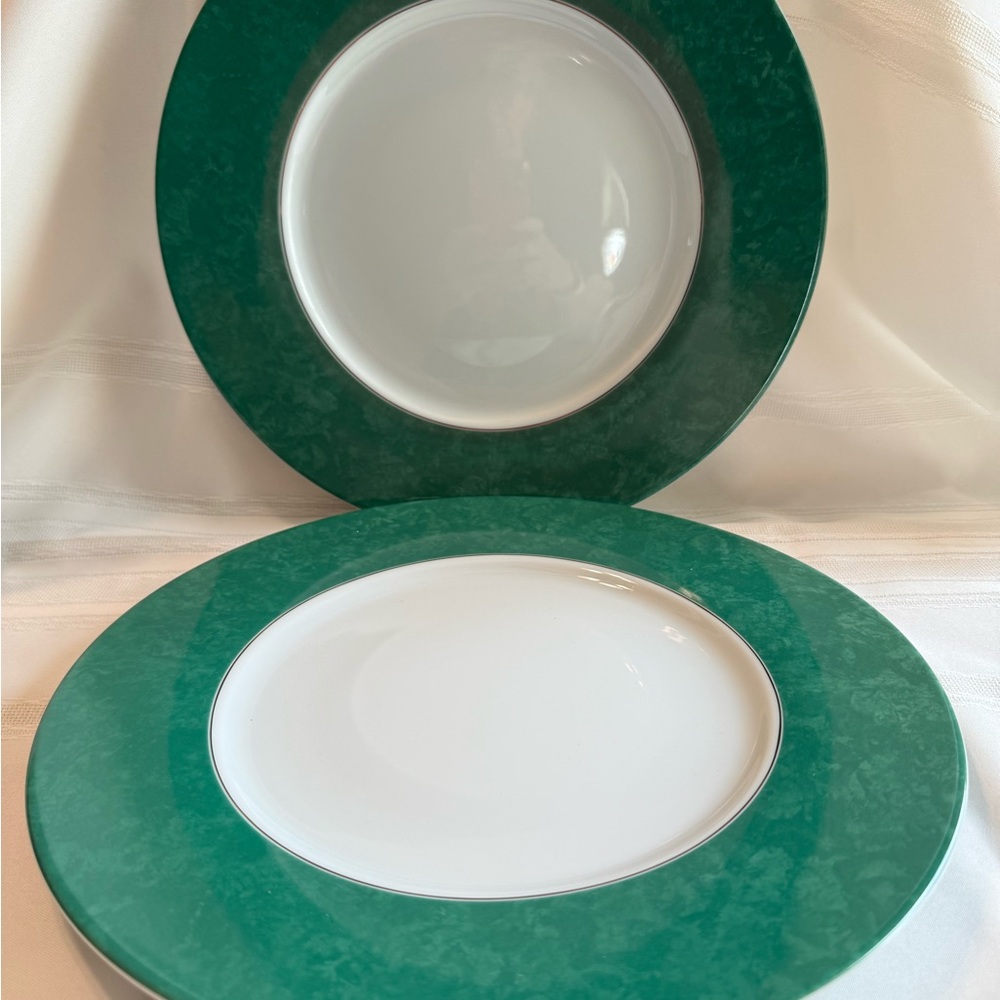 Christofle porcelain chargers in original box.